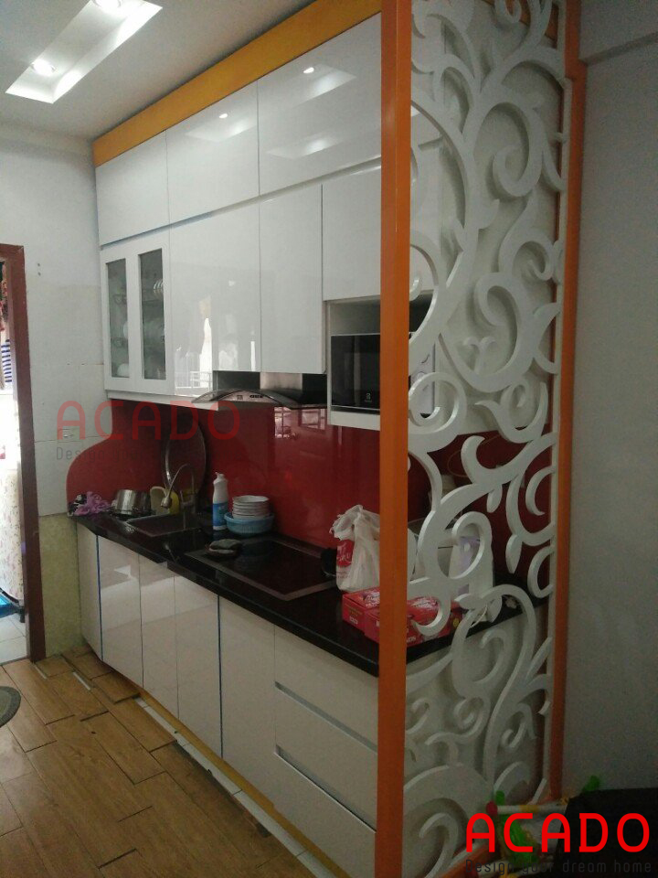 Tủ bếp acrylic trắng kết hợp với chút màu cam làm điểm nhấn khá ân tượng cho căn bếp.