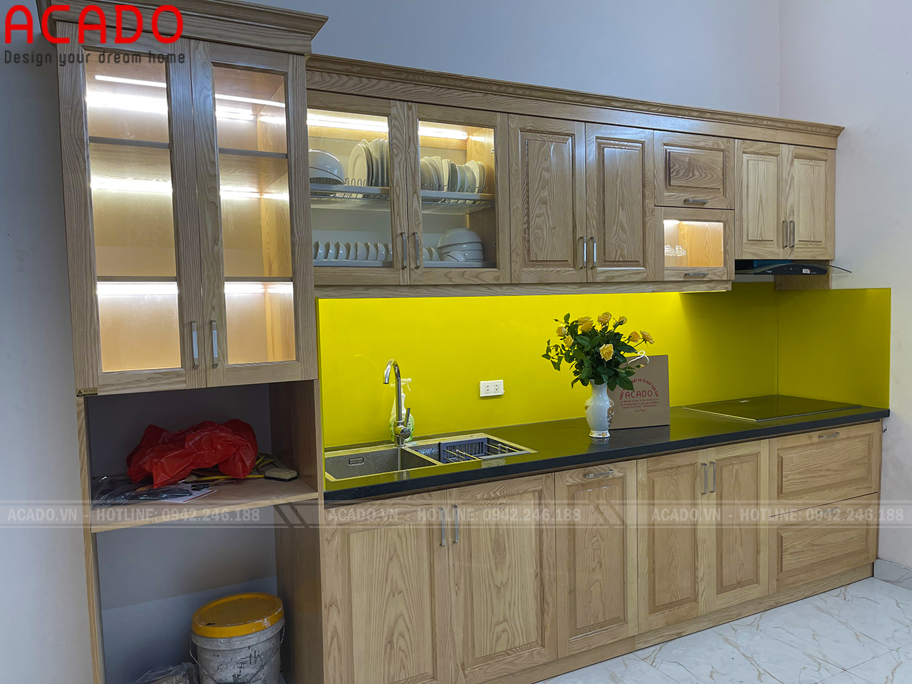 Tủ bếp màu vàng kêt hợp hai hòa với màu kính bếp tạo một vẻ đẹp thống nhất