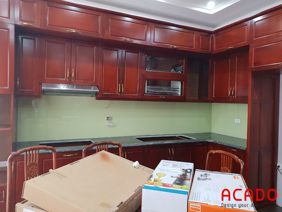 Tủ bếp gỗ gõ đỏ mang đến không gian ấm cúng, sang trọng.